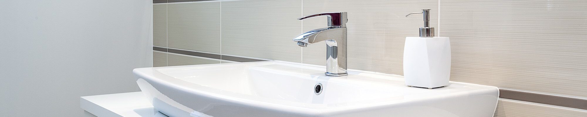 Bright space - a silver tap in a white bathroom