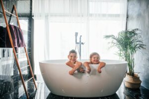 Two kids enjoying the new hot water cylinder
