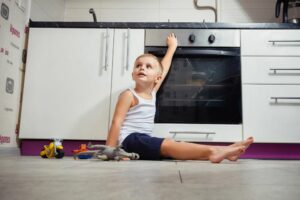 reliable gas safety in Wellington homes. Child playing near gas oven